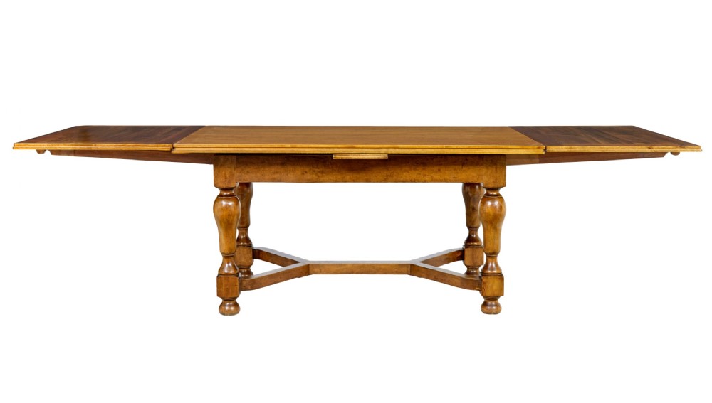 An early 20th-century birch extending dining table with a rectangular top, turned baluster legs, and a low central stretcher base. View V