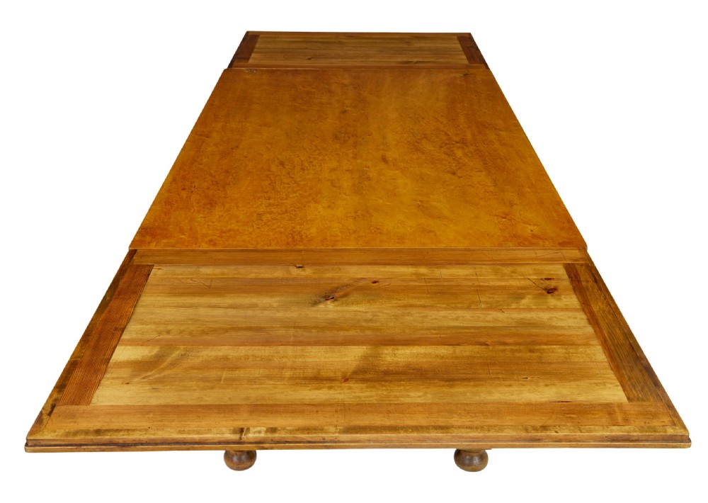 An early 20th-century birch extending dining table with a rectangular top, turned baluster legs, and a low central stretcher base. View VI
