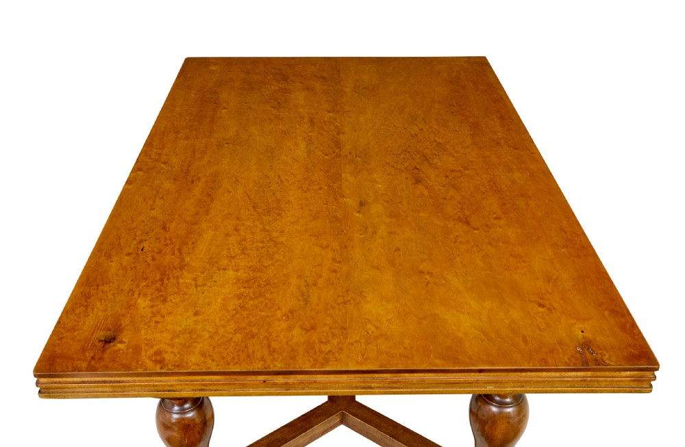 An early 20th-century birch extending dining table with a rectangular top, turned baluster legs, and a low central stretcher base. View VIII