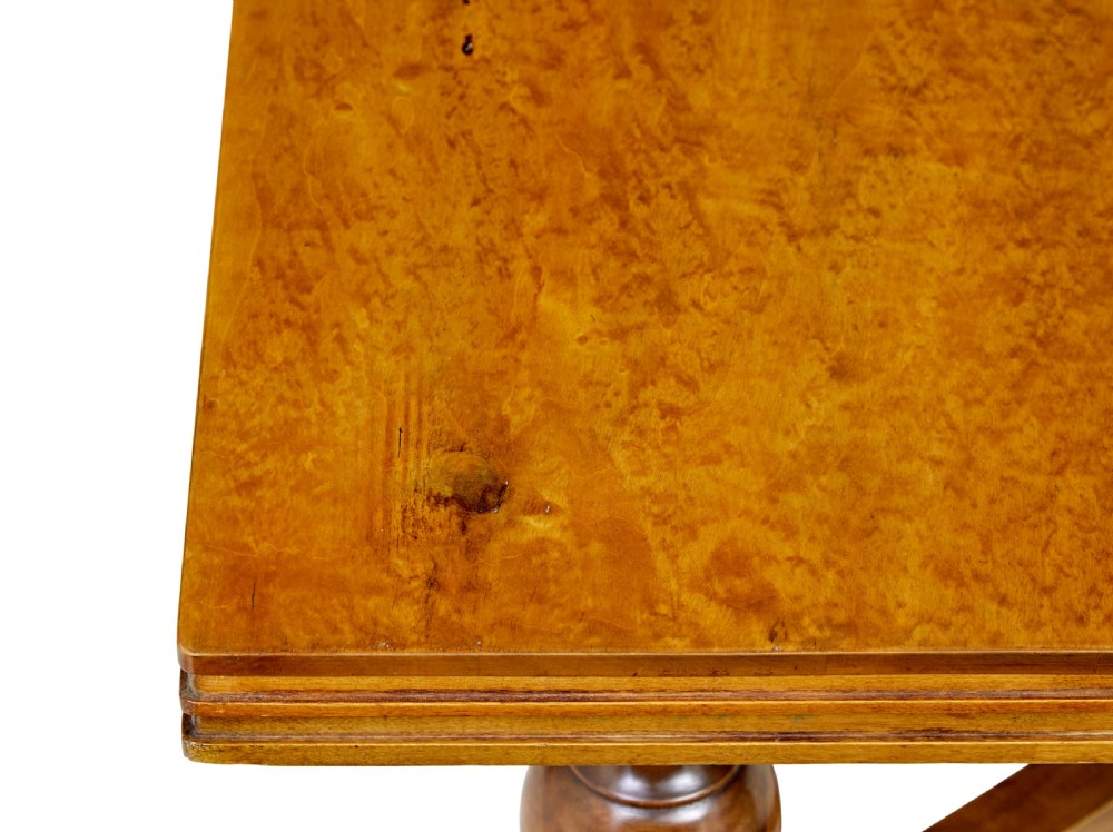 An early 20th-century birch extending dining table with a rectangular top, turned baluster legs, and a low central stretcher base. View IX