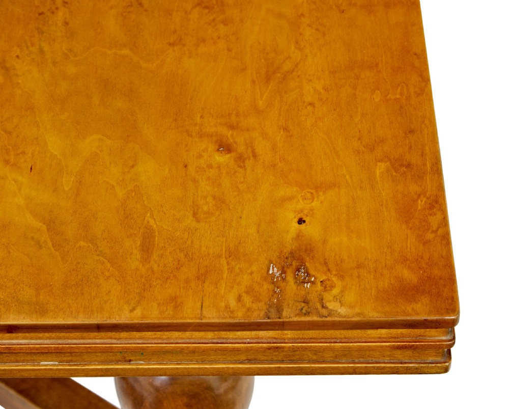 An early 20th-century birch extending dining table with a rectangular top, turned baluster legs, and a low central stretcher base. View X