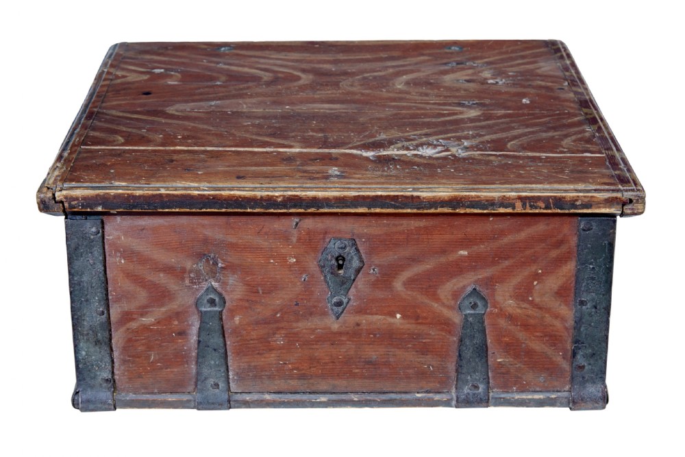 A 19th-century Scandinavian pine strongbox featuring a hand-painted faux grain finish in reddish-brown with forged iron corner mounts, base straps, and an iron escutcheon plate.