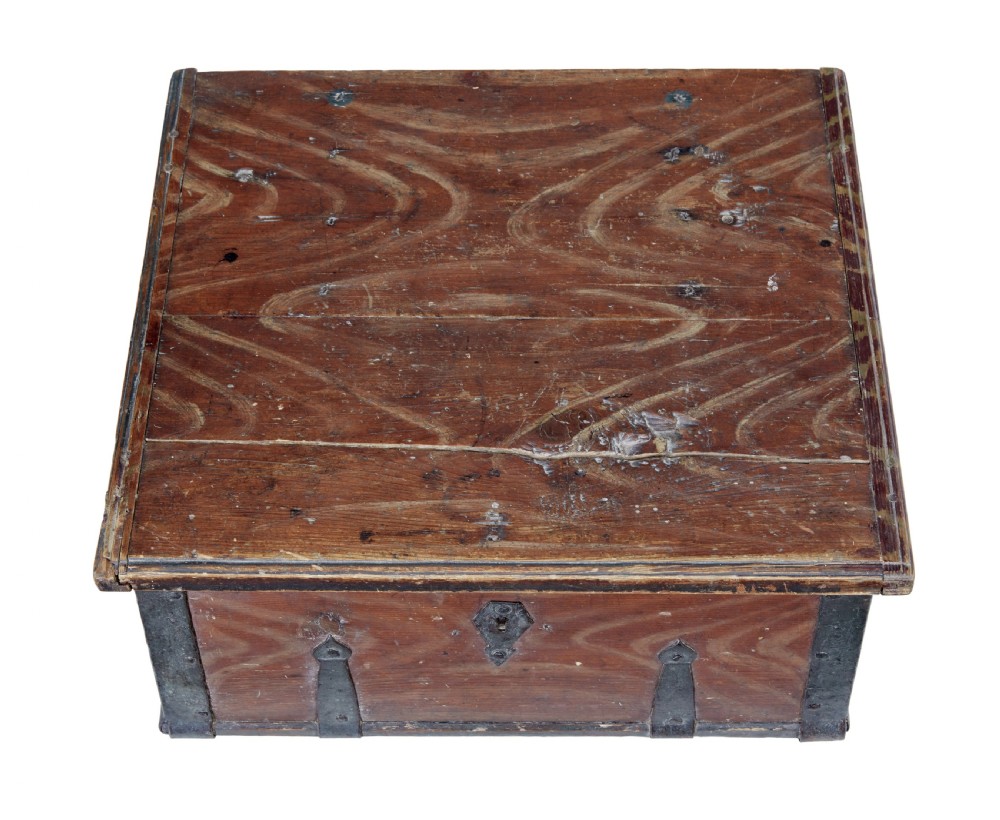 A 19th-century Scandinavian pine strongbox featuring a hand-painted faux grain finish in reddish-brown with forged iron corner mounts, base straps, and an iron escutcheon plate. View II
