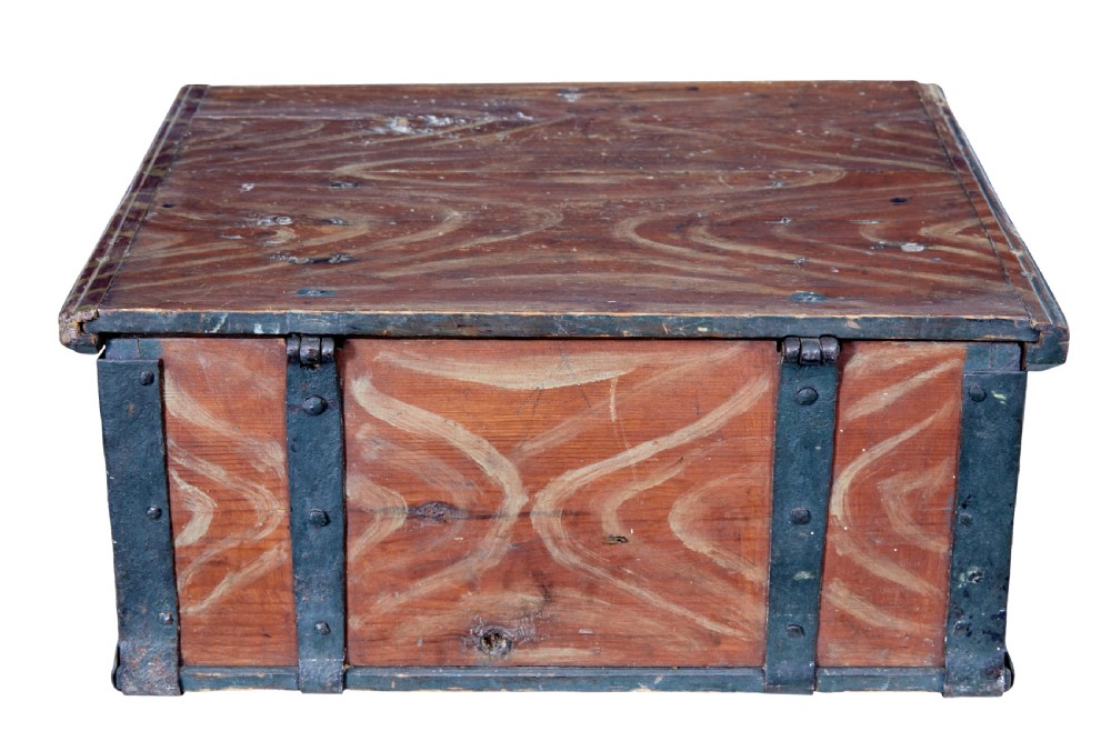 A 19th-century Scandinavian pine strongbox featuring a hand-painted faux grain finish in reddish-brown with forged iron corner mounts, base straps, and an iron escutcheon plate. View V