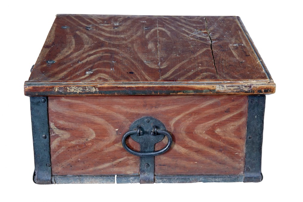 A 19th-century Scandinavian pine strongbox featuring a hand-painted faux grain finish in reddish-brown with forged iron corner mounts, base straps, and an iron escutcheon plate. View VI