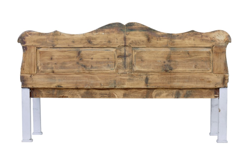 A white painted nineteenth-century Swedish Gustavian style wooden bench featuring a shaped crest rail, panelled back, and slatted side armrests. View V