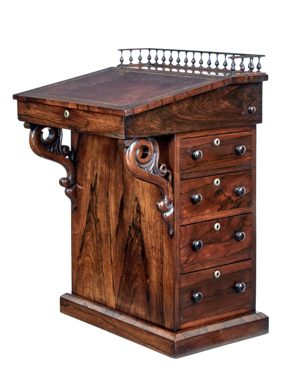A 19th-century Regency palisander Davenport desk featuring a sloped leather writing top, carved scroll brackets, side drawers, and a brass spindle top gallery.