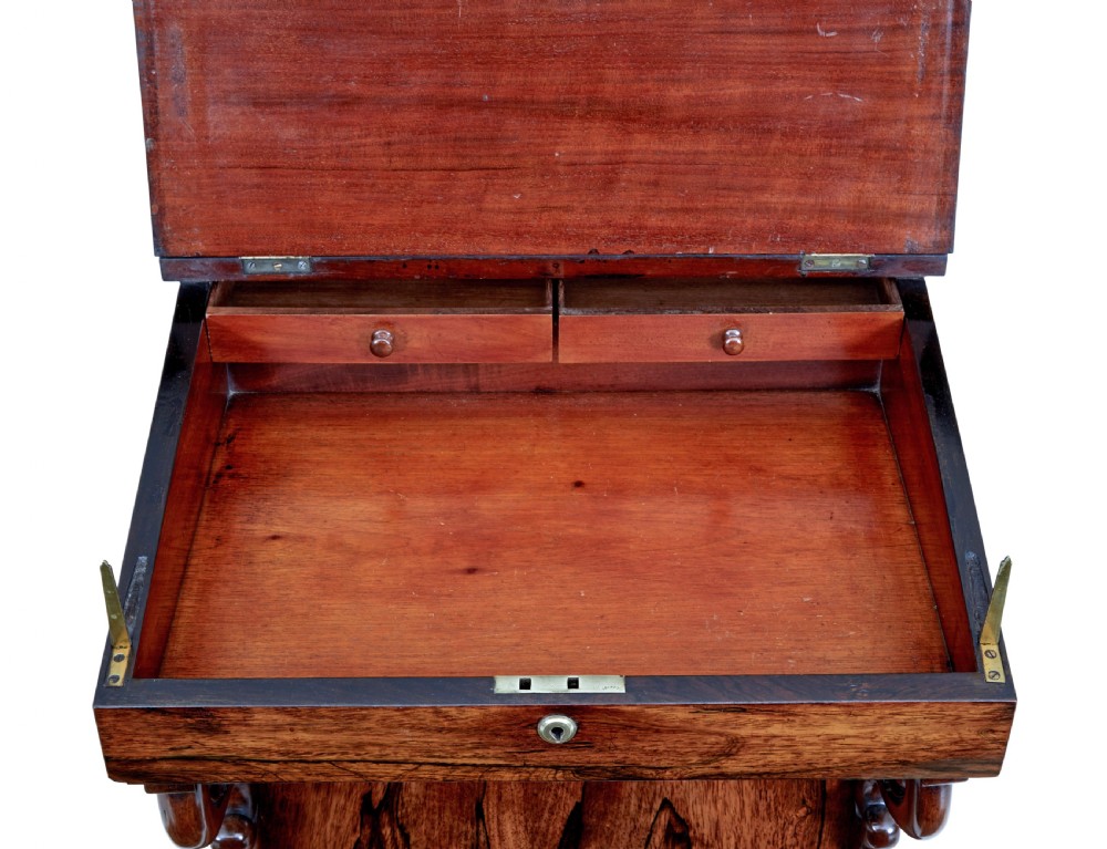 A 19th-century Regency palisander Davenport desk featuring a sloped leather writing top, carved scroll brackets, side drawers, and a brass spindle top gallery. View III