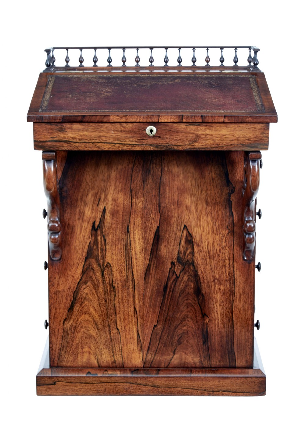 A 19th-century Regency palisander Davenport desk featuring a sloped leather writing top, carved scroll brackets, side drawers, and a brass spindle top gallery. View VI