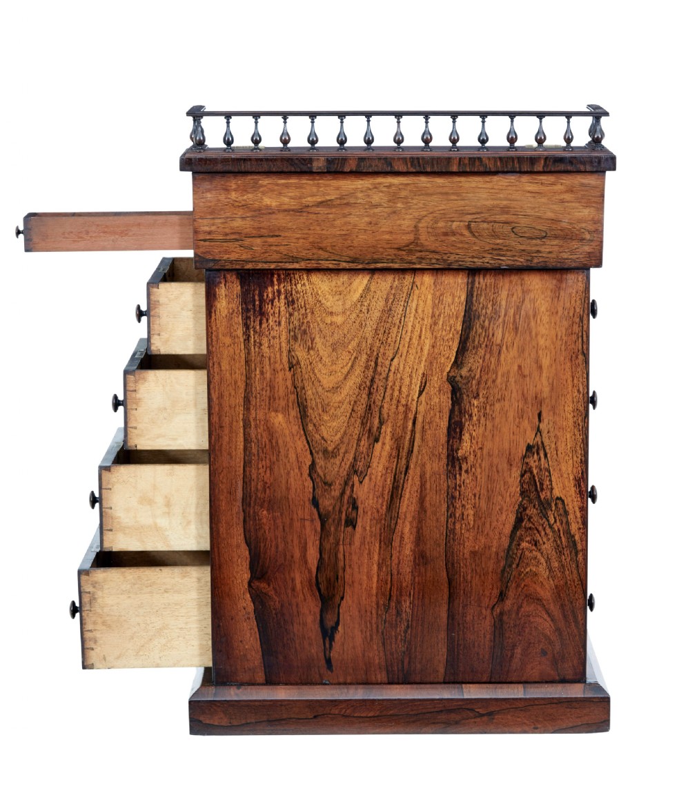 A 19th-century Regency palisander Davenport desk featuring a sloped leather writing top, carved scroll brackets, side drawers, and a brass spindle top gallery. View VIII