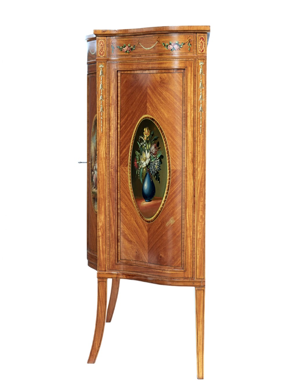 A late 19th-century Sheraton Revival satinwood cabinet featuring hand-painted floral swags, classical figurative oval panels, intricate wood marquetry, and tapered legs. View III