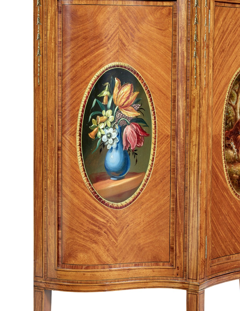 A late 19th-century Sheraton Revival satinwood cabinet featuring hand-painted floral swags, classical figurative oval panels, intricate wood marquetry, and tapered legs. View VI