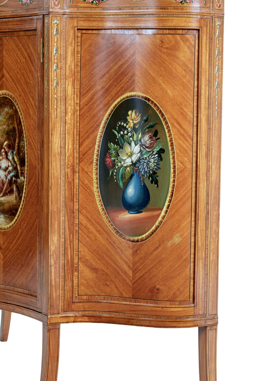 A late 19th-century Sheraton Revival satinwood cabinet featuring hand-painted floral swags, classical figurative oval panels, intricate wood marquetry, and tapered legs. View VII