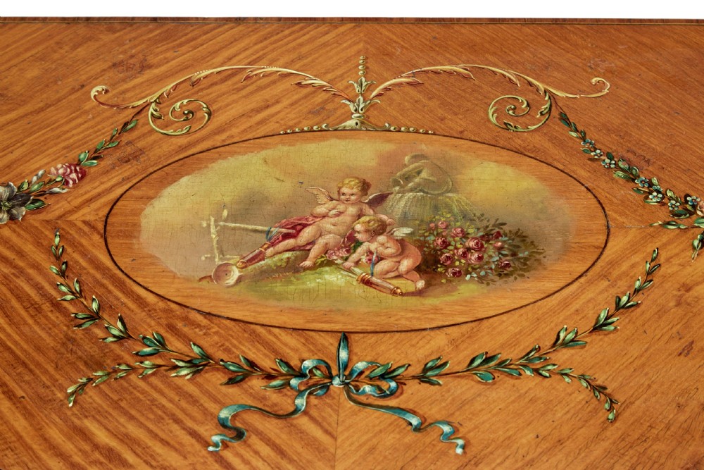 A late 19th-century Sheraton Revival satinwood cabinet featuring hand-painted floral swags, classical figurative oval panels, intricate wood marquetry, and tapered legs. View XI