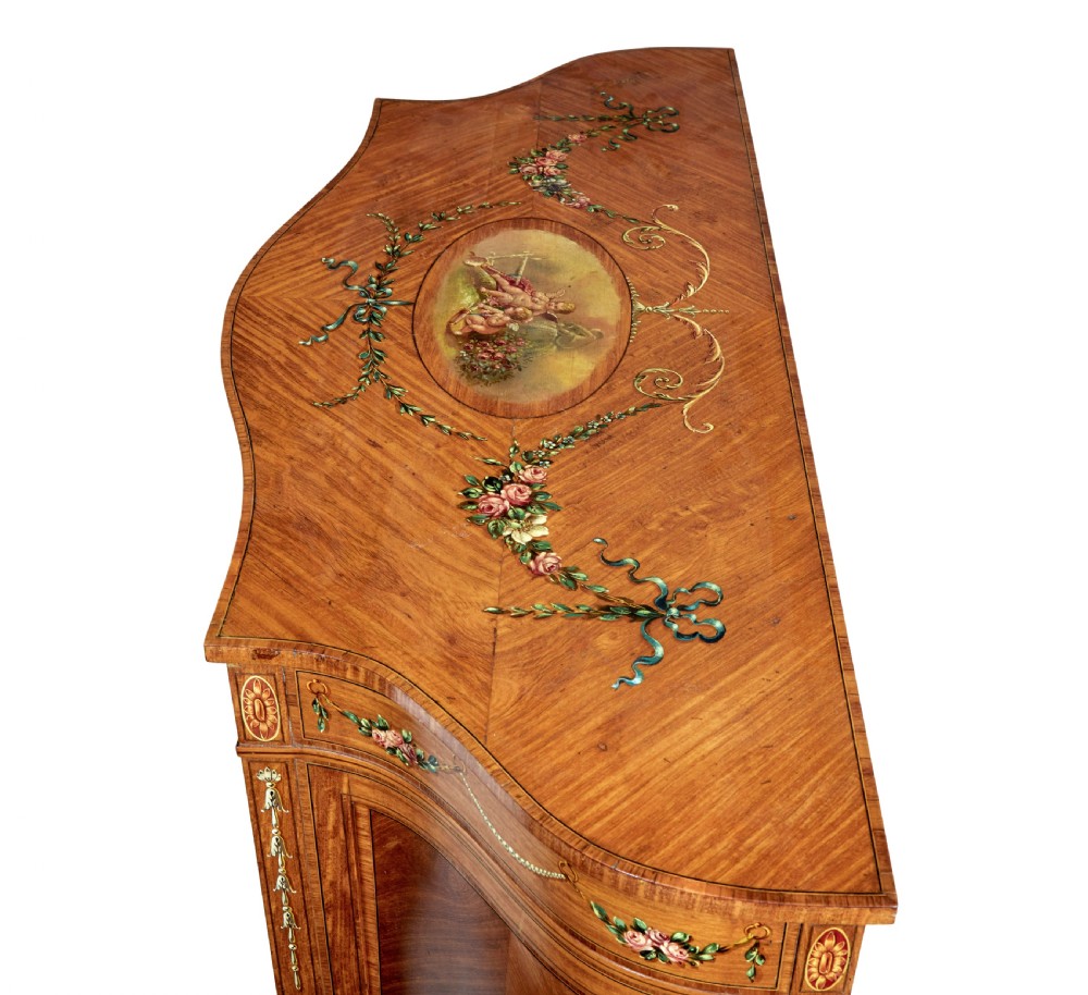 A late 19th-century Sheraton Revival satinwood cabinet featuring hand-painted floral swags, classical figurative oval panels, intricate wood marquetry, and tapered legs. View XII