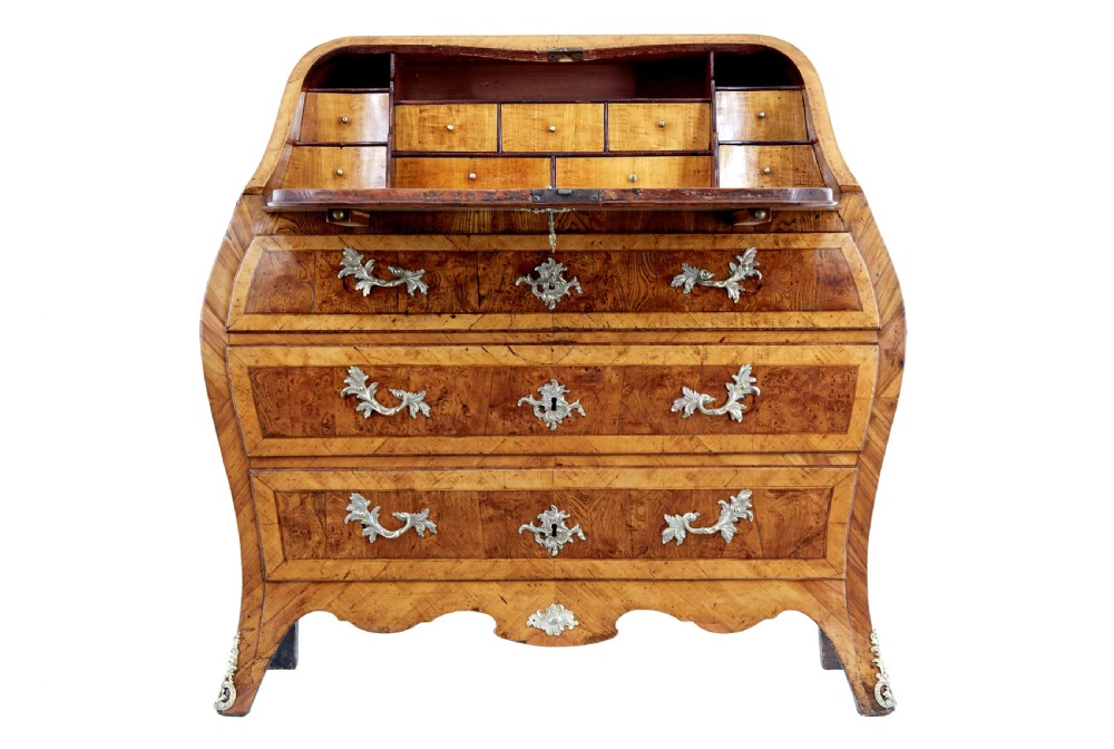An 18th-century Rococo bureau crafted from yew and elm wood featuring a curved bombe body, slant-front writing slope, three drawers, and decorative cast brass handles. View II