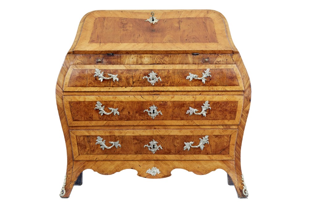 An 18th-century Rococo bureau crafted from yew and elm wood featuring a curved bombe body, slant-front writing slope, three drawers, and decorative cast brass handles. View III