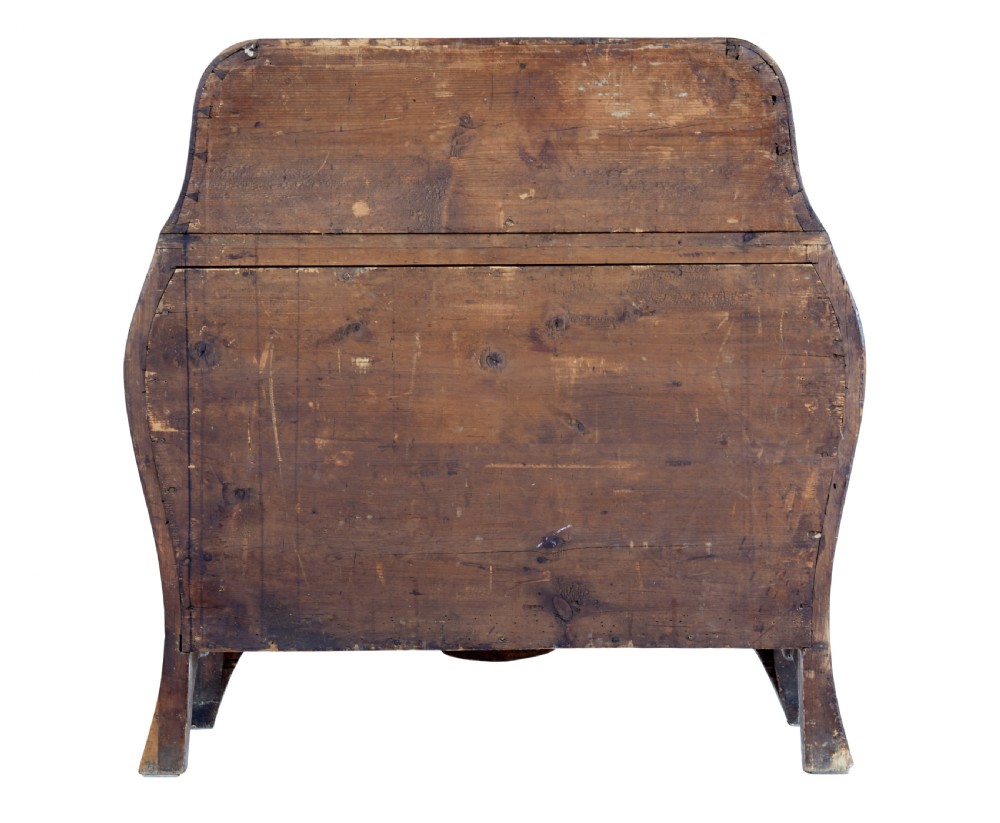 An 18th-century Rococo bureau crafted from yew and elm wood featuring a curved bombe body, slant-front writing slope, three drawers, and decorative cast brass handles. View VI