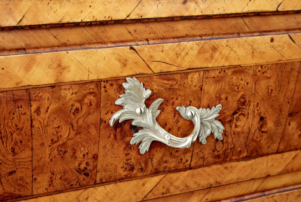 An 18th-century Rococo bureau crafted from yew and elm wood featuring a curved bombe body, slant-front writing slope, three drawers, and decorative cast brass handles. View VIII