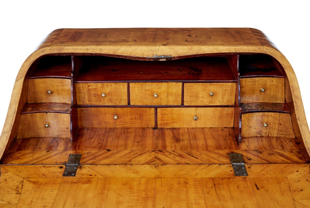 An 18th-century Rococo bureau crafted from yew and elm wood featuring a curved bombe body, slant-front writing slope, three drawers, and decorative cast brass handles. View XI