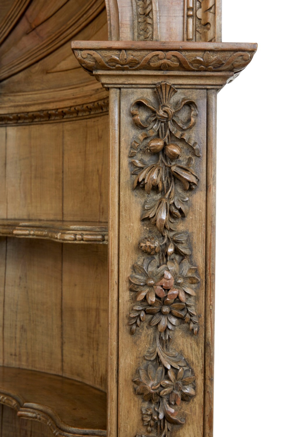 An 18th-century carved pine corner cabinet featuring a vaulted dome top with a shell carving, floral pilasters, open shelves, and a double-door base. View VIII