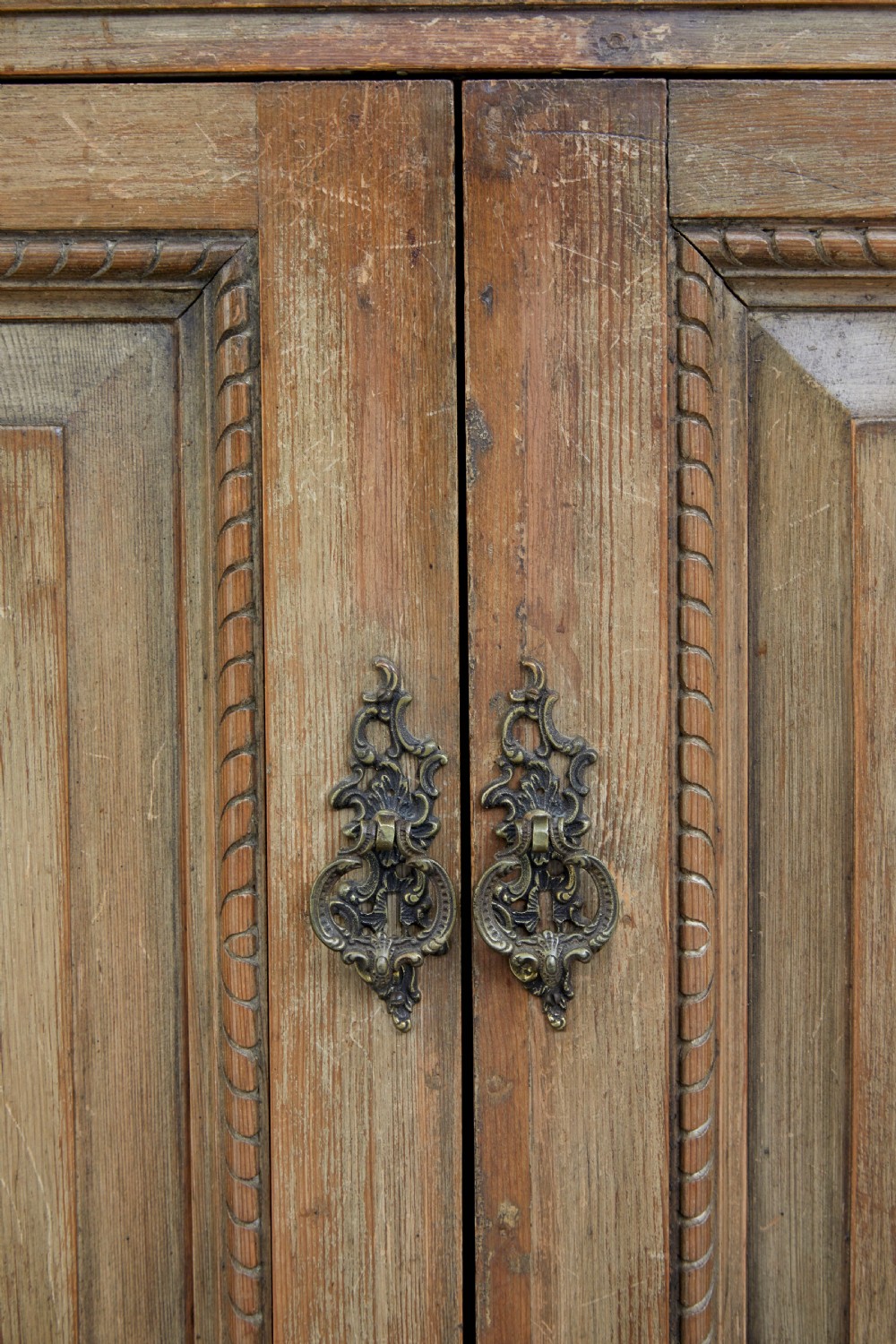 An 18th-century carved pine corner cabinet featuring a vaulted dome top with a shell carving, floral pilasters, open shelves, and a double-door base. View IX