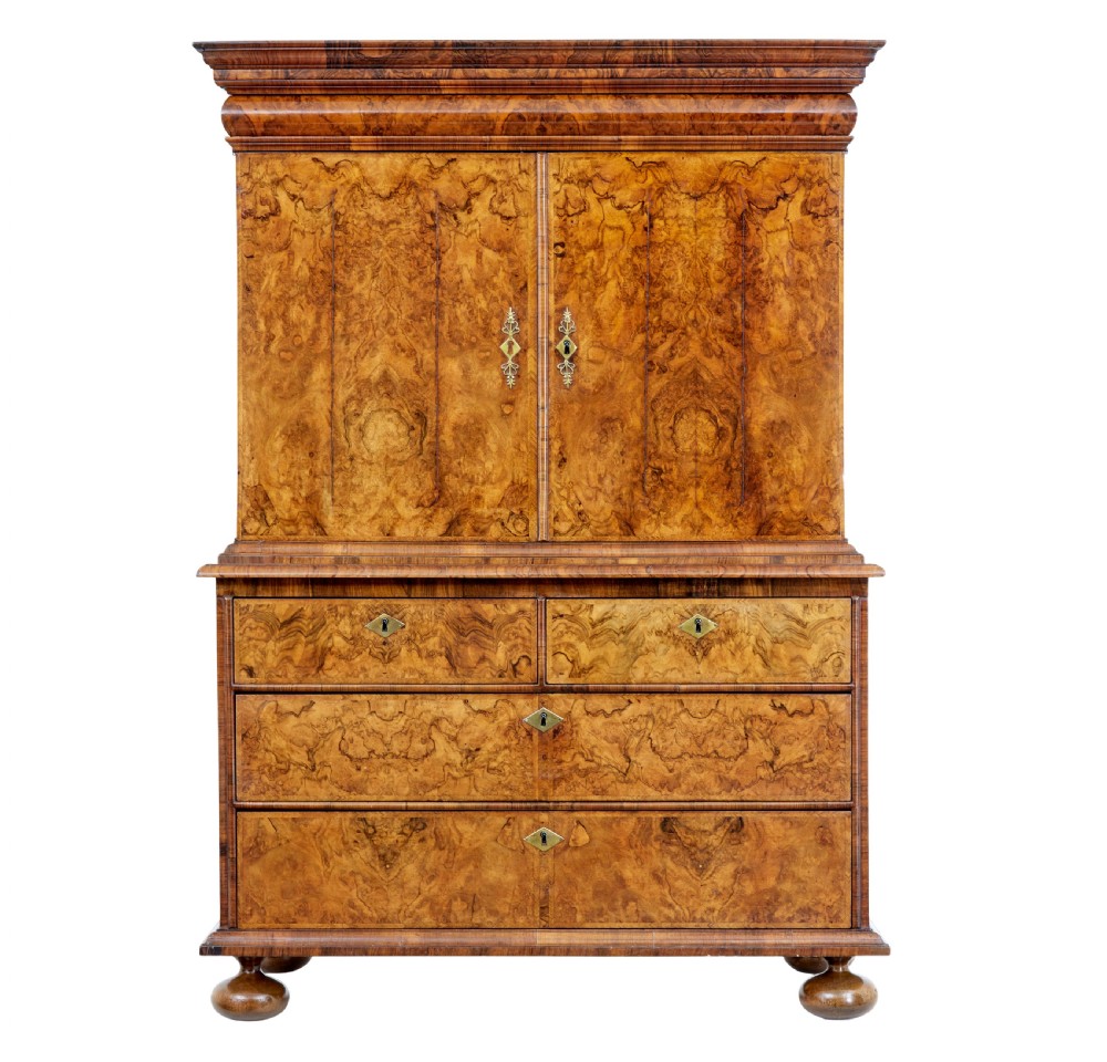 An 18th-century George I burr walnut cabinet on chest featuring double upper doors, brass keyhole escutcheons, and turned bun feet. View II