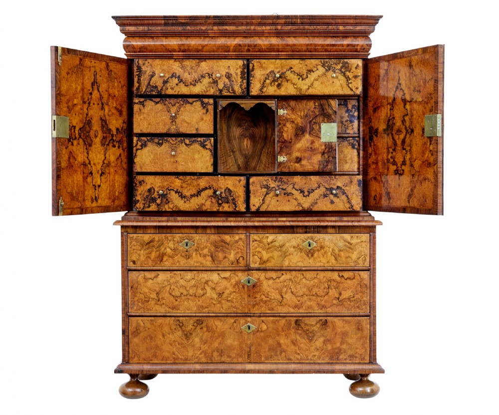 An 18th-century George I burr walnut cabinet on chest featuring double upper doors, brass keyhole escutcheons, and turned bun feet. View IV