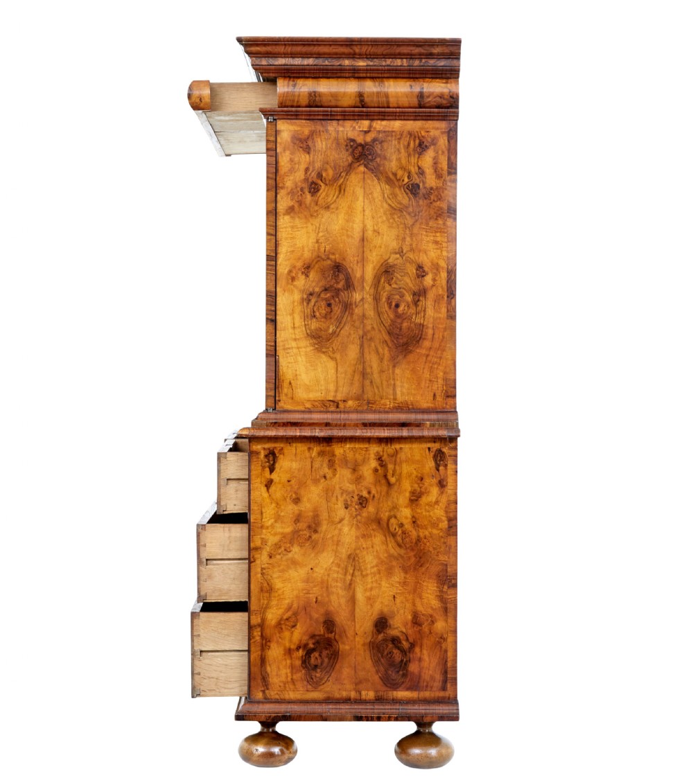 An 18th-century George I burr walnut cabinet on chest featuring double upper doors, brass keyhole escutcheons, and turned bun feet. View VI