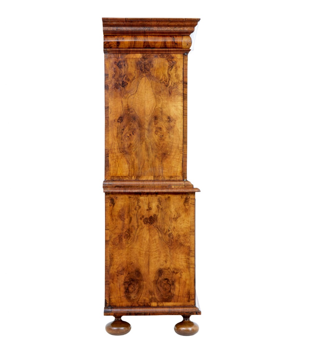 An 18th-century George I burr walnut cabinet on chest featuring double upper doors, brass keyhole escutcheons, and turned bun feet. View VIII