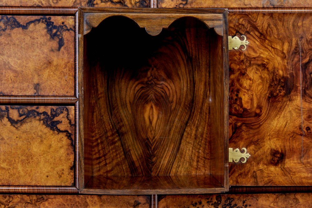 An 18th-century George I burr walnut cabinet on chest featuring double upper doors, brass keyhole escutcheons, and turned bun feet. View XI