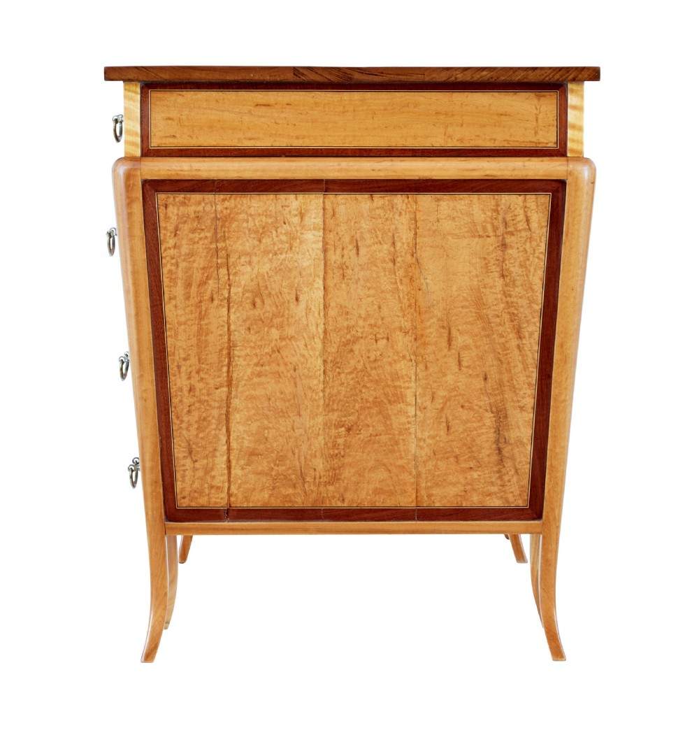 An early 20th-century Sheraton Revival satinwood pedestal desk featuring inlaid mahogany crossbanding, seven drawers with brass handles, and gently splayed legs. View V