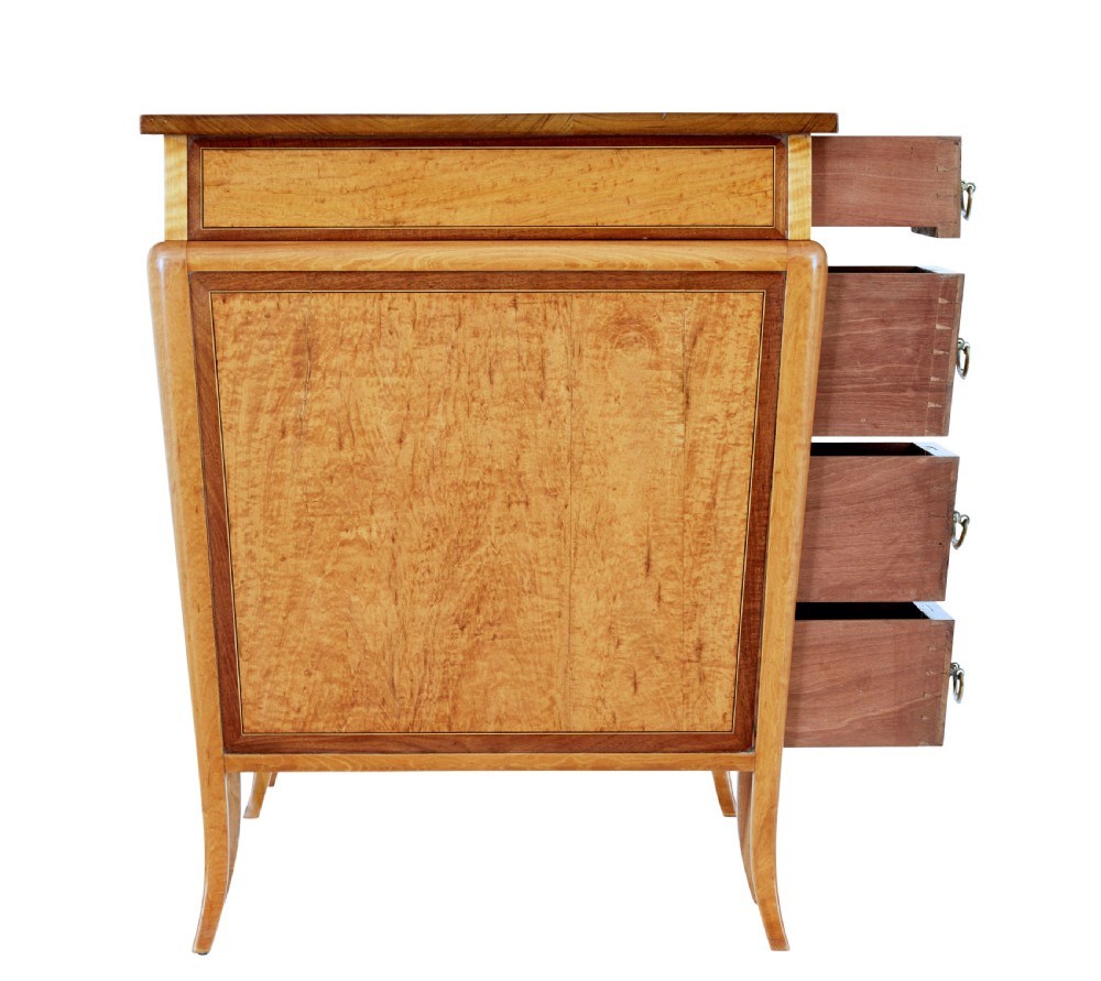 An early 20th-century Sheraton Revival satinwood pedestal desk featuring inlaid mahogany crossbanding, seven drawers with brass handles, and gently splayed legs. View VII