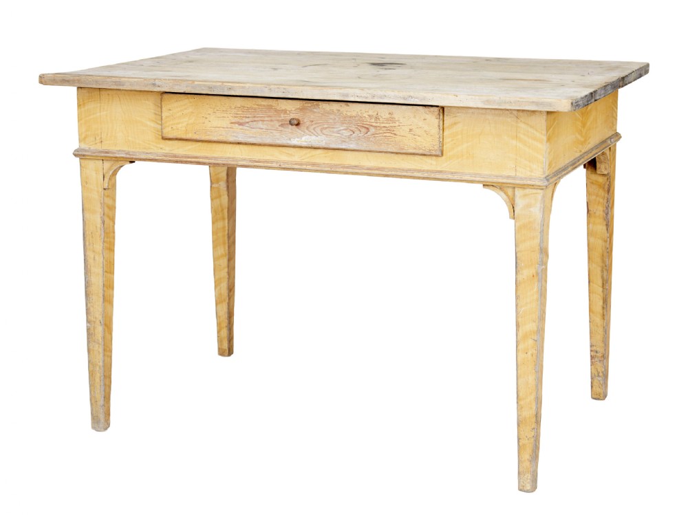A 19th-century Swedish pine kitchen table featuring a yellow painted frame, square tapered legs, a single frieze drawer, and a scrubbed wooden tabletop.