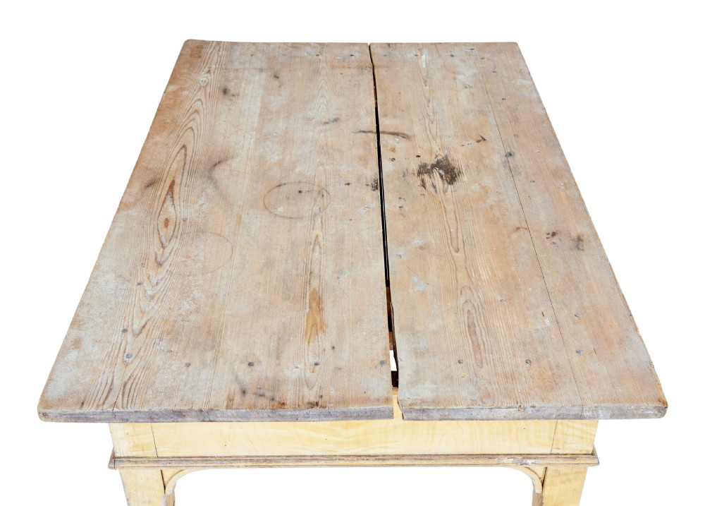 A 19th-century Swedish pine kitchen table featuring a yellow painted frame, square tapered legs, a single frieze drawer, and a scrubbed wooden tabletop. View II
