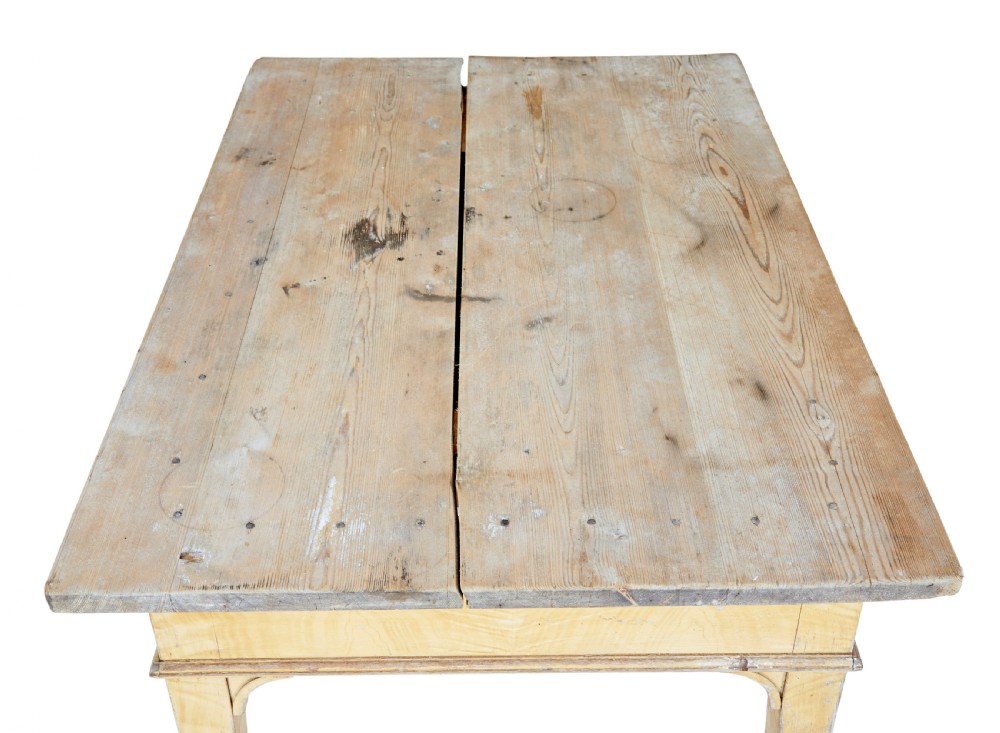 A 19th-century Swedish pine kitchen table featuring a yellow painted frame, square tapered legs, a single frieze drawer, and a scrubbed wooden tabletop. View III