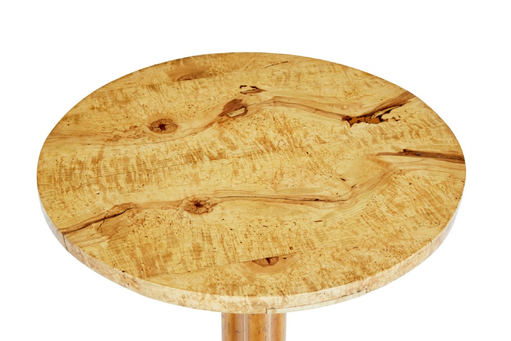 A mid-19th century occasional table featuring a circular top in figured birch root wood set upon a central column and three curved tripod legs. View II