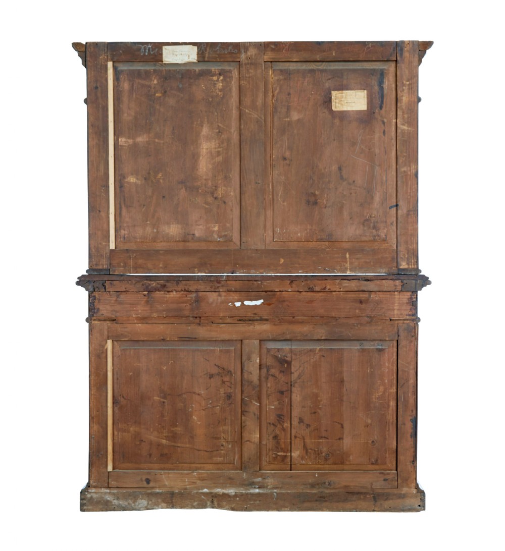 A large 19th-century Flemish dark carved oak cabinet featuring intricate relief panels depicting human figures and architectural details. View IV