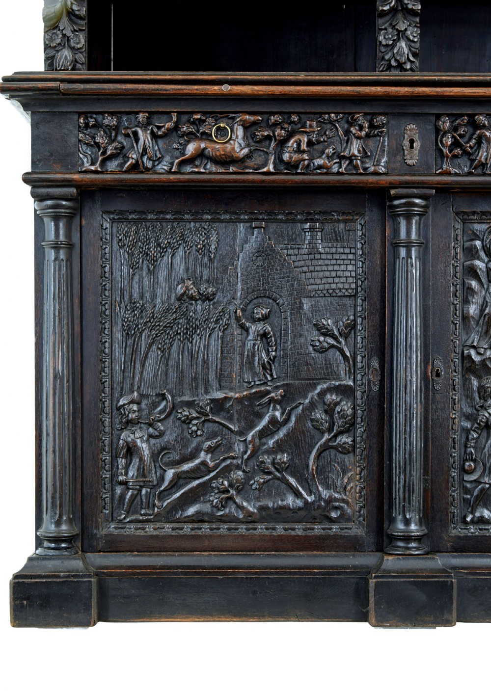 A large 19th-century Flemish dark carved oak cabinet featuring intricate relief panels depicting human figures and architectural details. View X