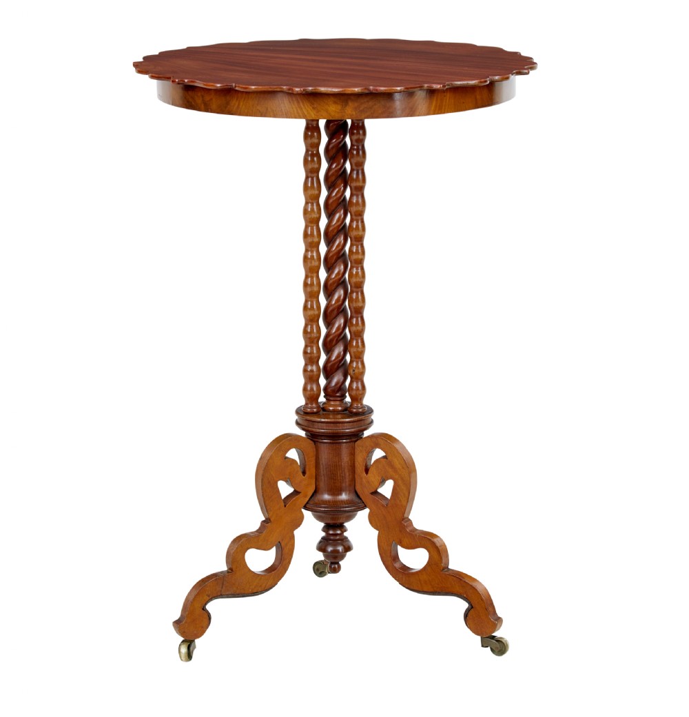 A late 19th-century mahogany occasional table featuring a scalloped piecrust top, central bobbin-turned supports, and a tripod scroll base with brass castors. View III