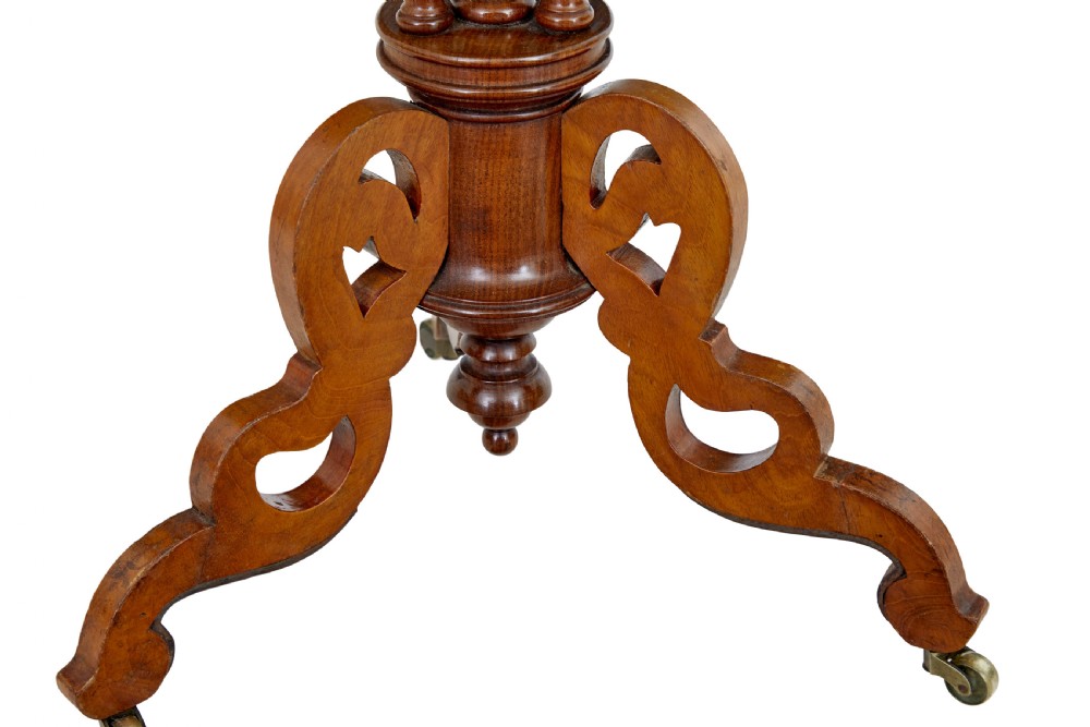 A late 19th-century mahogany occasional table featuring a scalloped piecrust top, central bobbin-turned supports, and a tripod scroll base with brass castors. View VI