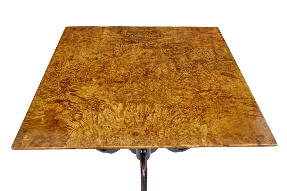 A nineteenth-century Swedish tilt-top side table featuring a square golden alder root top set on a dark turned central column with three splayed legs. View II