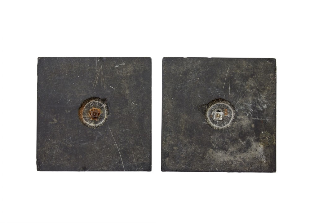 A pair of brass obelisks with incised hieroglyphic carvings mounted on stepped black marble bases. View V