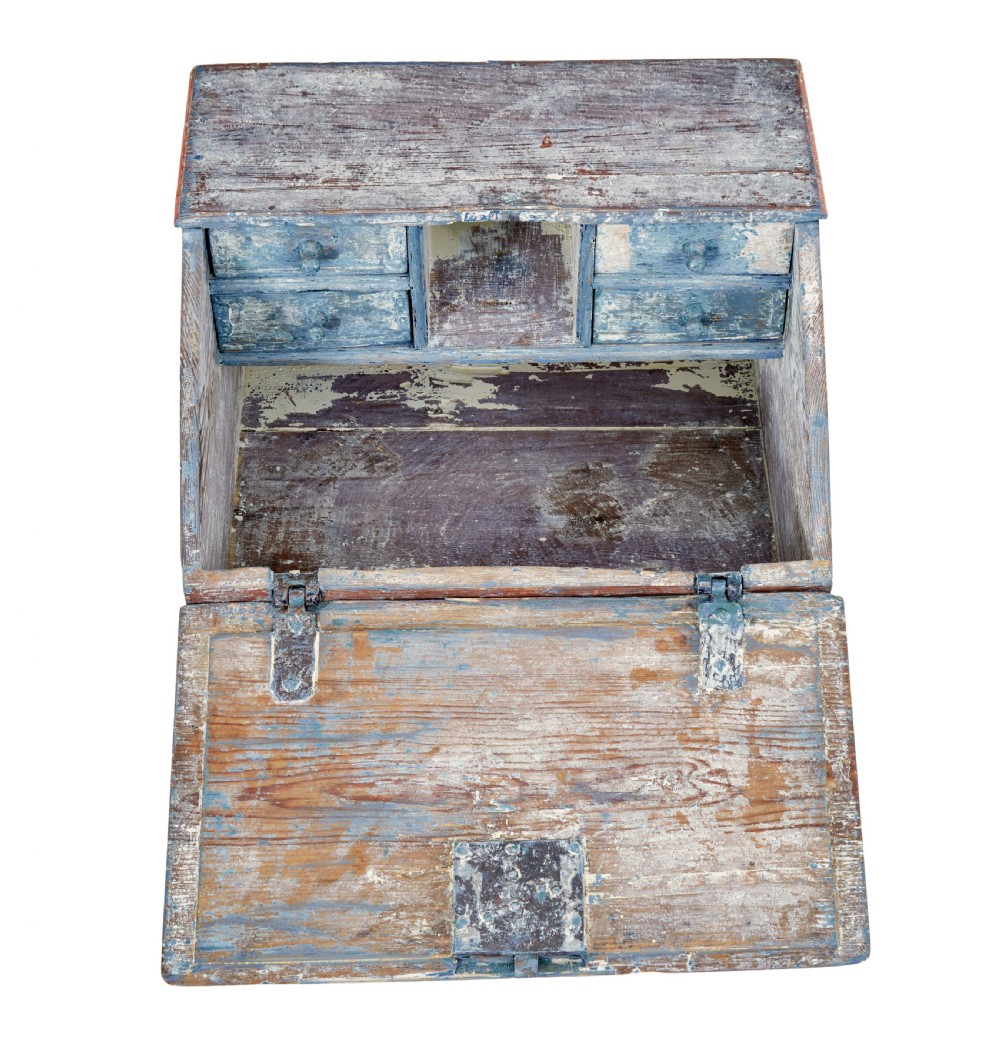 A mid 19th-century Swedish wooden tabletop writing desk with a slanted lid, distressed red and grey paint finish, and a hand-painted foliage wreath motif around the keyhole. View III