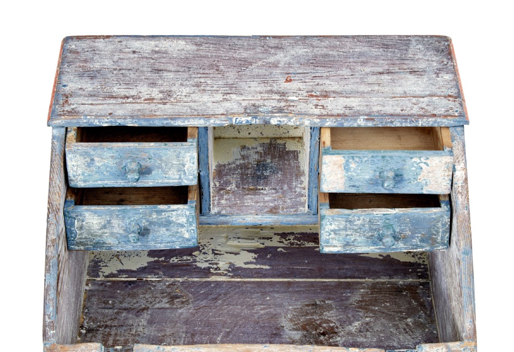 A mid 19th-century Swedish wooden tabletop writing desk with a slanted lid, distressed red and grey paint finish, and a hand-painted foliage wreath motif around the keyhole. View V