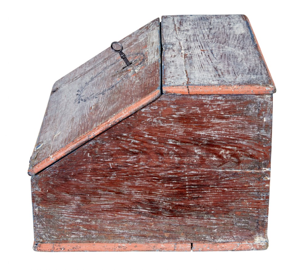 A mid 19th-century Swedish wooden tabletop writing desk with a slanted lid, distressed red and grey paint finish, and a hand-painted foliage wreath motif around the keyhole. View VII