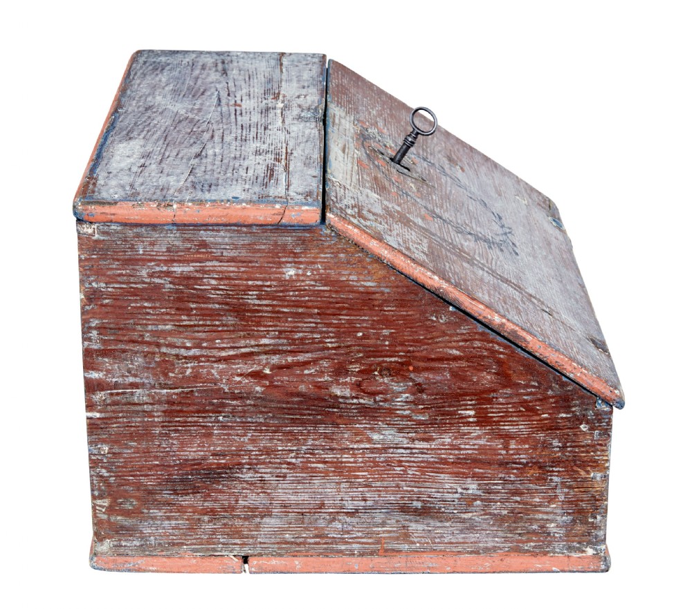 A mid 19th-century Swedish wooden tabletop writing desk with a slanted lid, distressed red and grey paint finish, and a hand-painted foliage wreath motif around the keyhole. View IX