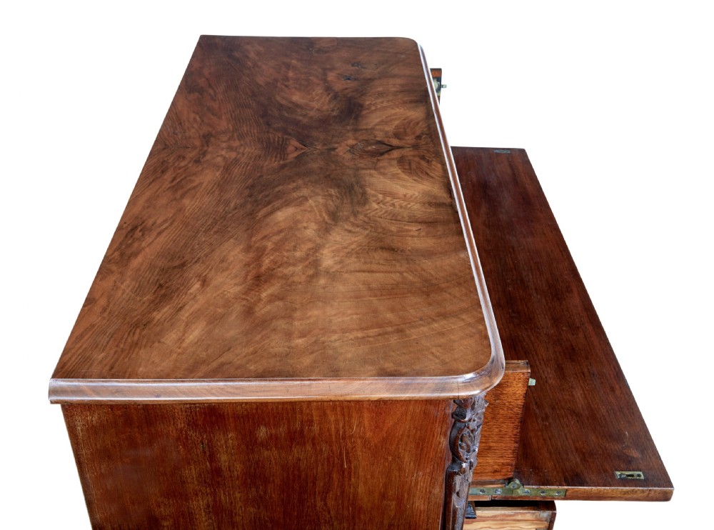 A nineteenth-century burr walnut secretaire chest of drawers featuring book-matched veneer drawer fronts and cast brass drop handles. View VII