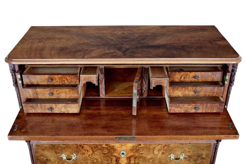 A nineteenth-century burr walnut secretaire chest of drawers featuring book-matched veneer drawer fronts and cast brass drop handles. View X