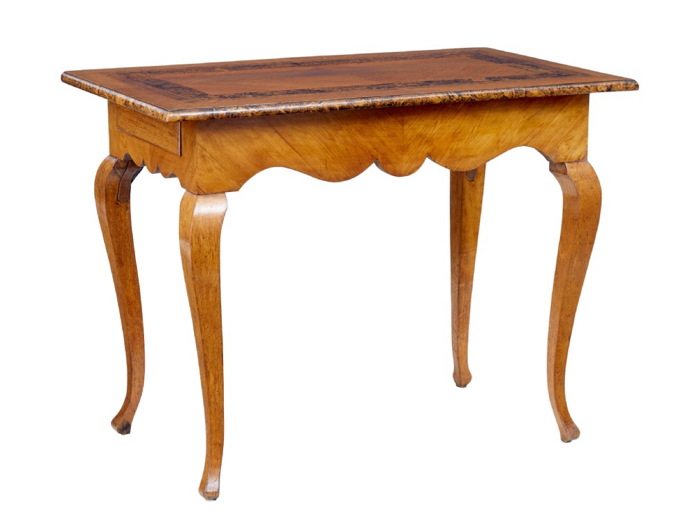 A mid 19th-century Swedish rectangular occasional table crafted from golden brown alder root wood with slender cabriole legs and a contoured apron.